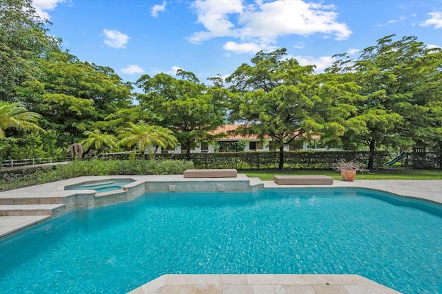 view of swimming pool with an in ground hot tub