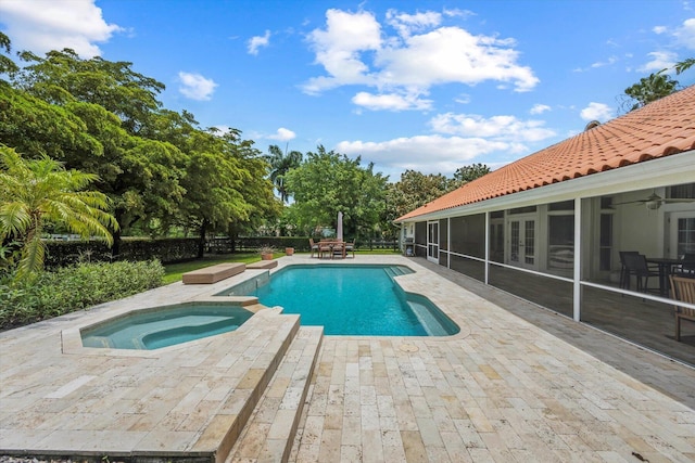 view of swimming pool with an in ground hot tub, a patio area, and a sunroom