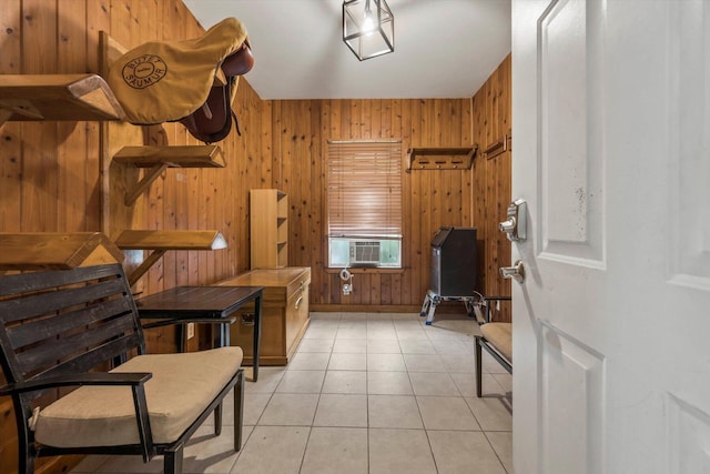 interior space featuring wood walls, cooling unit, and light tile patterned floors