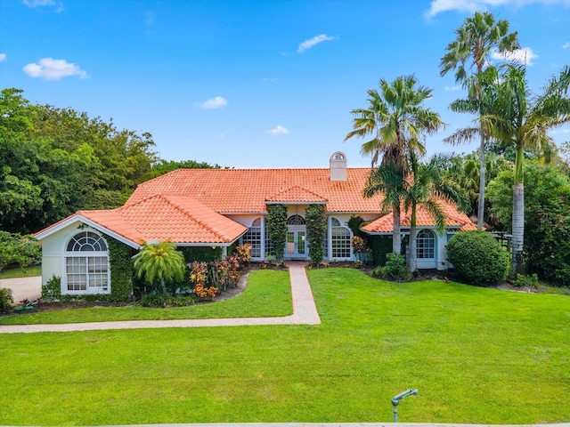 mediterranean / spanish home featuring a front yard