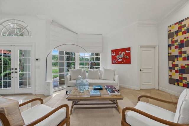 tiled living room with french doors, a towering ceiling, and a healthy amount of sunlight