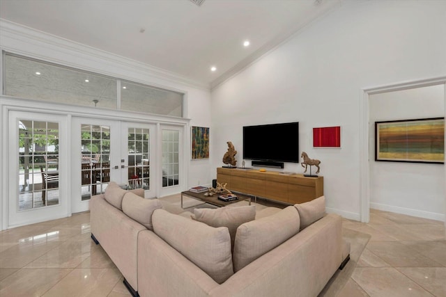 living room with a towering ceiling, crown molding, and french doors