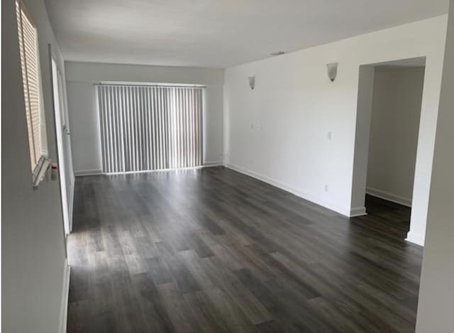 spare room with dark hardwood / wood-style floors