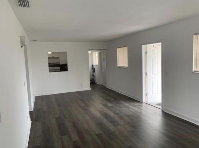 empty room featuring dark hardwood / wood-style flooring