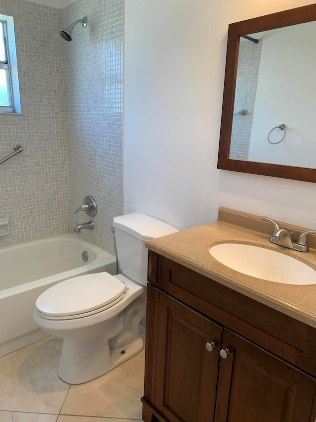 full bathroom with tile flooring, toilet, vanity, and tiled shower / bath