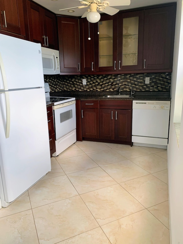 kitchen with backsplash, ceiling fan, sink, and white appliances