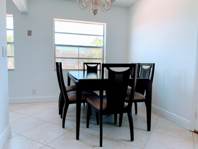 tiled dining area featuring a notable chandelier