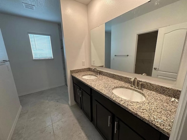 bathroom with tile floors and double sink vanity