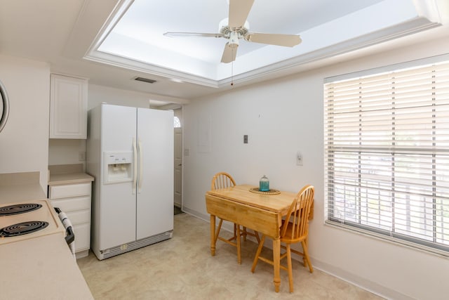 kitchen featuring white cabinets, ceiling fan, a raised ceiling, and white appliances