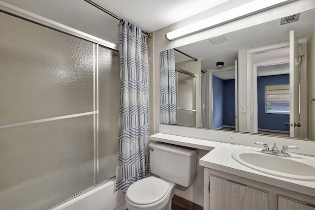 full bathroom featuring shower / bath combination with glass door, vanity, and toilet