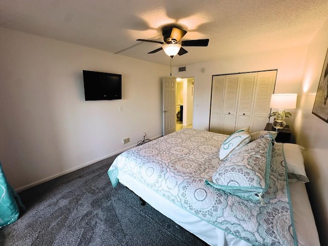 bedroom with dark colored carpet, a closet, a textured ceiling, and ceiling fan