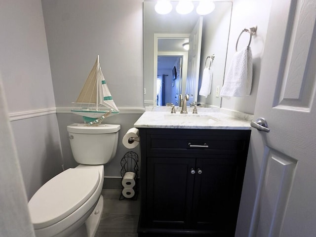 bathroom featuring toilet, vanity, and tile patterned flooring