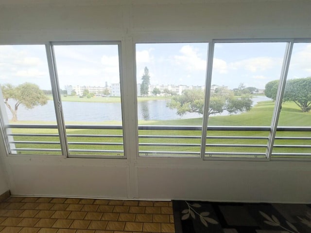 sunroom featuring a water view and a wealth of natural light