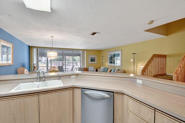 kitchen with sink, pendant lighting, light brown cabinetry, and stainless steel dishwasher