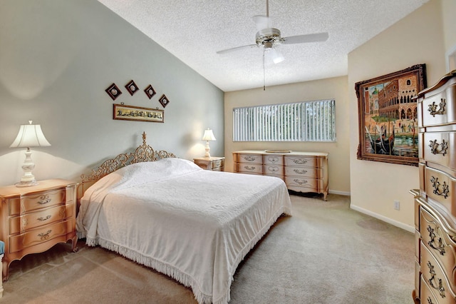 carpeted bedroom featuring ceiling fan and a textured ceiling