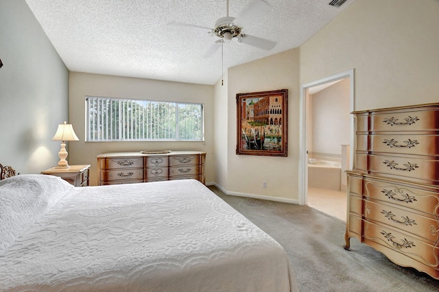 bedroom featuring ceiling fan, carpet floors, vaulted ceiling, ensuite bathroom, and a textured ceiling