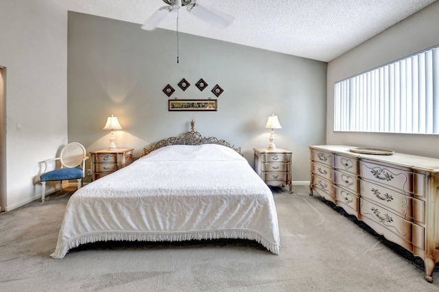 carpeted bedroom with ceiling fan and a textured ceiling