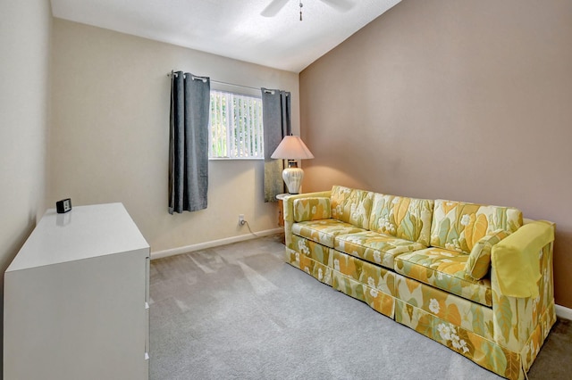 carpeted living room with ceiling fan and vaulted ceiling