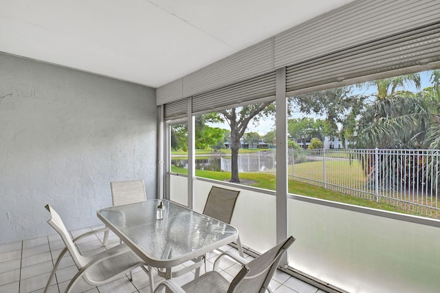 unfurnished sunroom featuring a water view