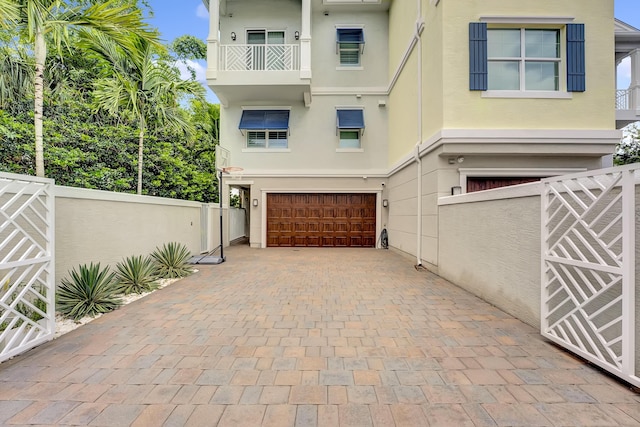 view of front of property with a garage and a balcony