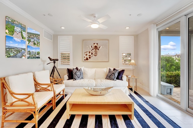 sitting room with ceiling fan and crown molding