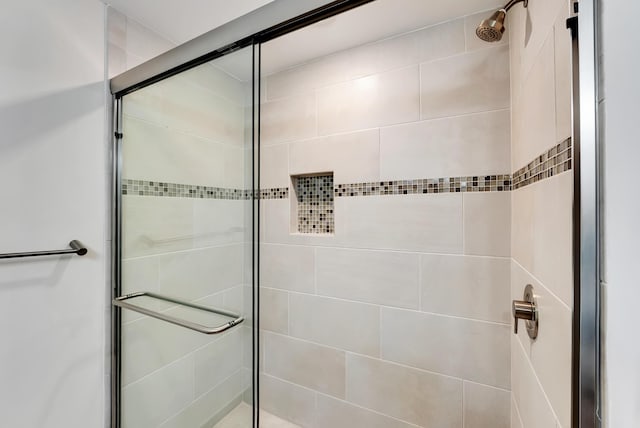 bathroom with a shower with shower door