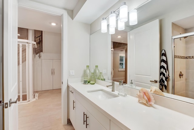 bathroom featuring vanity and an enclosed shower