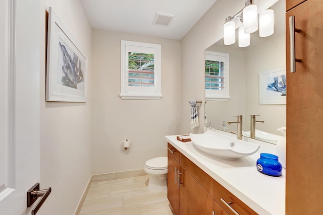 bathroom with tile patterned floors, vanity, and toilet