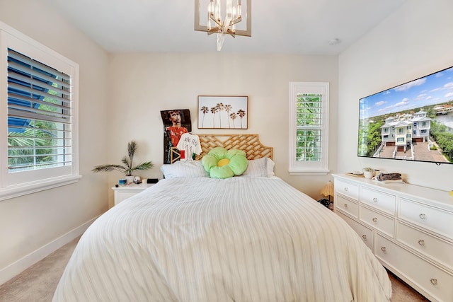 carpeted bedroom with a chandelier