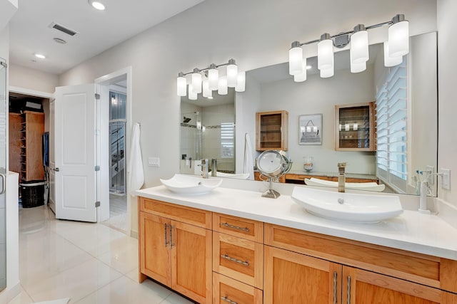 bathroom with tile patterned floors, vanity, and an enclosed shower