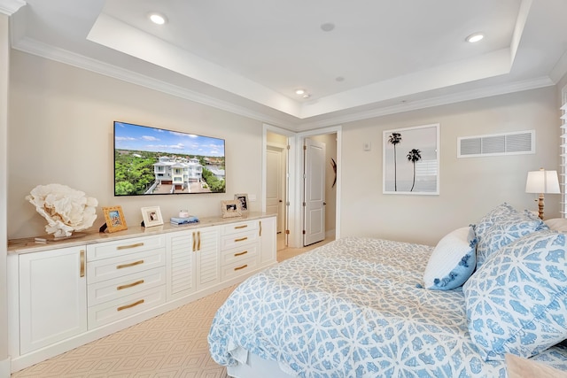 bedroom with a tray ceiling, light carpet, and ornamental molding