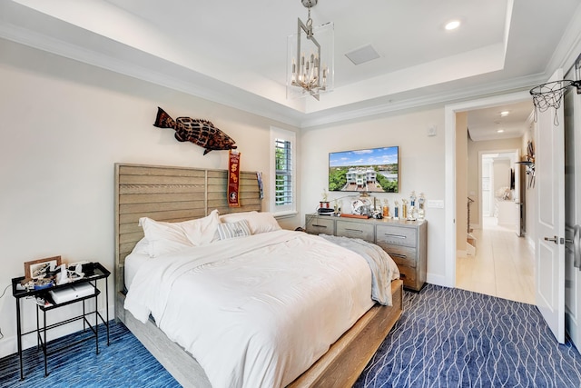 bedroom with an inviting chandelier, crown molding, and a tray ceiling