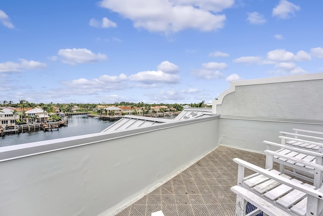 view of patio / terrace with a water view and a balcony