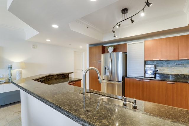 kitchen with decorative backsplash, dark stone counters, stainless steel refrigerator with ice dispenser, and ornamental molding