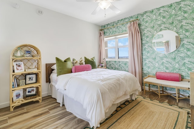2640 Lake Shore Dr Unit 1508, Riviera Beach, FL 33404 - bedroom with wallpapered walls, wood finished floors, and a ceiling fan