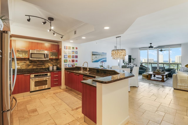 2640 Lake Shore Dr Unit 1508, Riviera Beach, FL 33404 - kitchen with stainless steel appliances, a peninsula, crown molding, modern cabinets, and stone tile flooring