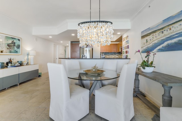 dining room with ornamental molding and an inviting chandelier