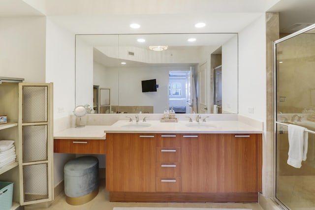 bathroom featuring vanity and a shower with door