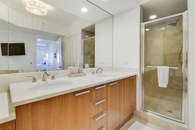 bathroom with vanity and a shower with shower door