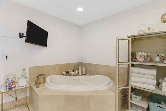 bathroom with tile patterned flooring and a relaxing tiled tub