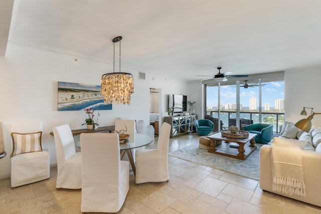 dining area with crown molding and ceiling fan with notable chandelier