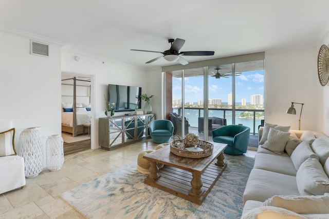 living room with ceiling fan and ornamental molding