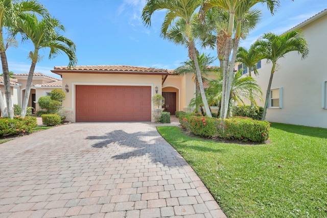 mediterranean / spanish-style house featuring a garage and a front lawn