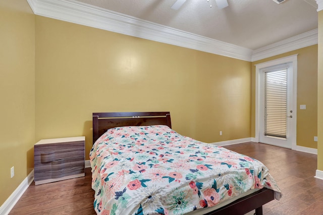 bedroom with ceiling fan, dark hardwood / wood-style floors, and crown molding