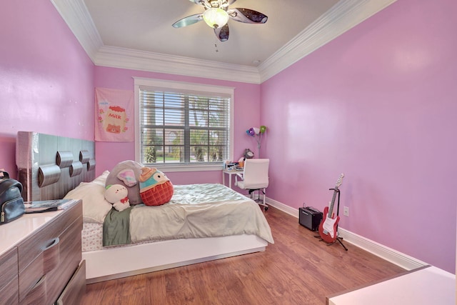 bedroom featuring ceiling fan, hardwood / wood-style floors, and crown molding