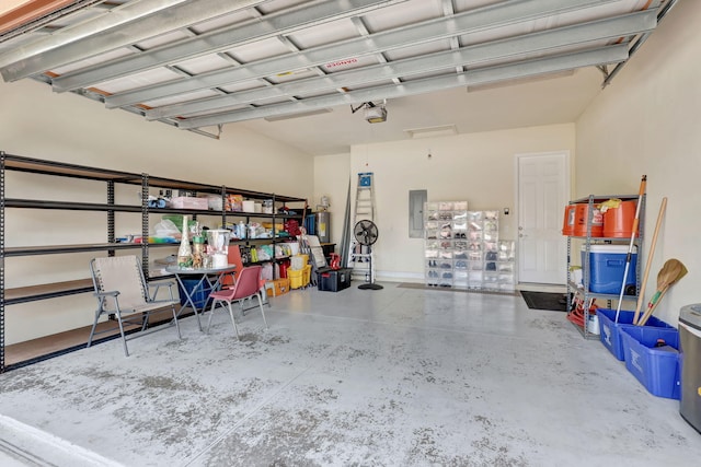 garage with electric panel and a garage door opener