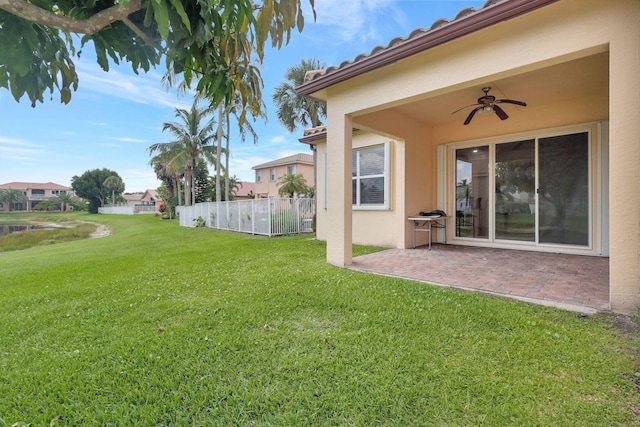 view of yard with a patio and ceiling fan