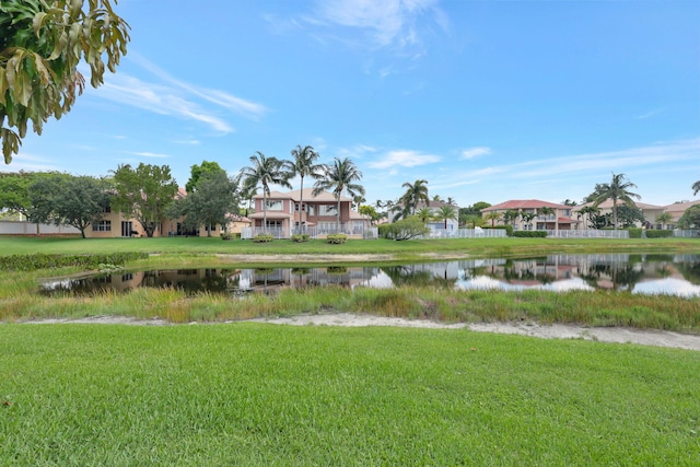 surrounding community featuring a yard and a water view