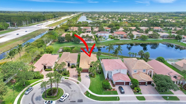 birds eye view of property with a water view