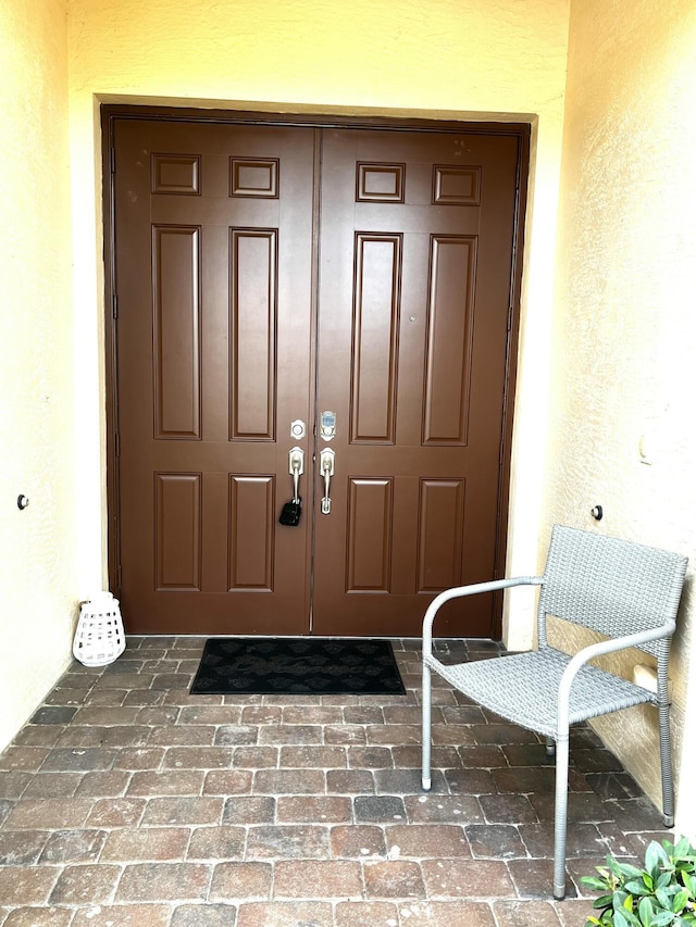 property entrance with stucco siding